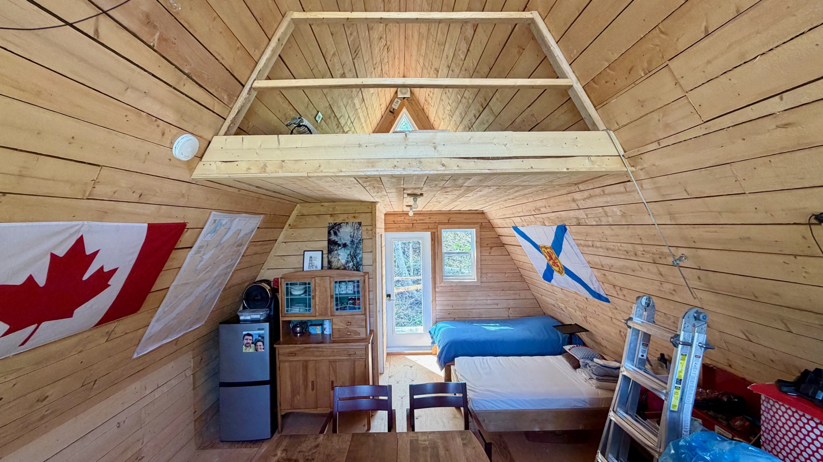 Interior of the aframe looking toward the beds and the loft above